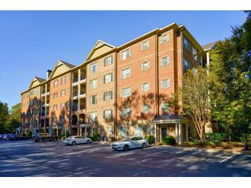 Brick building exterior with ample parking at 2300 Peachford Rd # 1205, Dunwoody, GA 30338