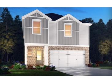 Two-story home with gray siding, brick accents, and a two-car garage at 2761 Hawthorne Way, College Park, GA 30337