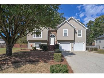 Two-story house with stone accents, attached garage, and mature tree at 4072 Staghorn Ct, Douglasville, GA 30135