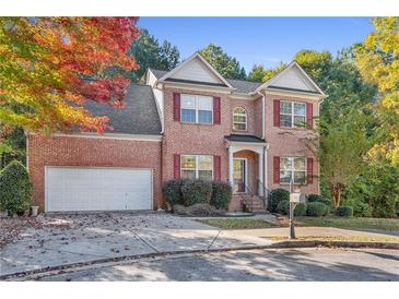 Two-story brick home with attached garage and landscaping at 110 Big Elk Sw Ct, Atlanta, GA 30349