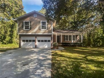 Two-car garage and front yard landscaping at 2988 Woodrow Mnr, Lithonia, GA 30038