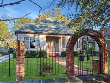 Charming craftsman home with brick walkway and wrought iron fence at 668 Peeples Sw St, Atlanta, GA 30310