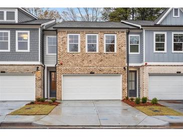 Brick front exterior of townhome with 2-car garage at 1072 Rose Dr, Marietta, GA 30060