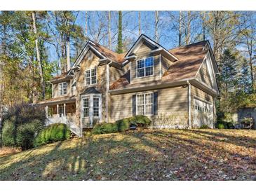 Two story house with stone accents and a large yard at 6020 Cherokee Trce, Cumming, GA 30041