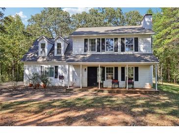 Two-story white house with black shutters and a front porch at 4012 Union Church Sw Rd, Stockbridge, GA 30281