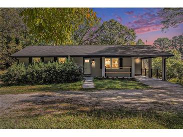 Updated ranch home with covered porch and landscaping at 93 Floyd Ln, Hampton, GA 30228