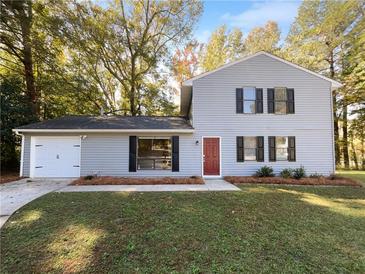Two-story house with attached garage and landscaping at 125 Cainwood W Ct, Atlanta, GA 30349