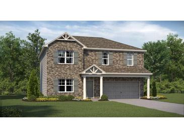 Two story home with brick facade and attached garage at 1261 Arnhem Dr, Hampton, GA 30228