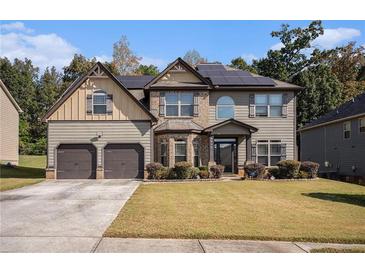 Two-story house with solar panels and a large yard at 6918 Diamond Dr, Rex, GA 30273