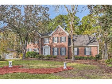 Brick house with a two-car garage and manicured lawn at 2582 Fairview Ln, Jonesboro, GA 30236