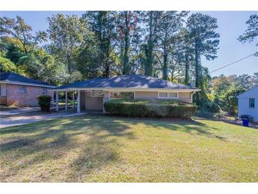 Ranch style home with carport, mature landscaping, and large yard at 2775 Tilson Rd, Decatur, GA 30032