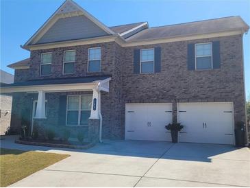 Two-story brick house with three-car garage and landscaping at 368 Sawyer Meadow Way, Grayson, GA 30017