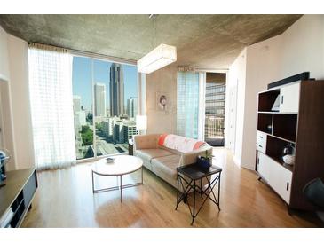Modern living room with hardwood floors and city views at 400 W Peachtree Nw St # 1713, Atlanta, GA 30308