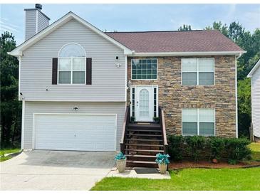 Two-story house with stone accents and a large driveway at 4118 Lost Springs Trl, Douglasville, GA 30135