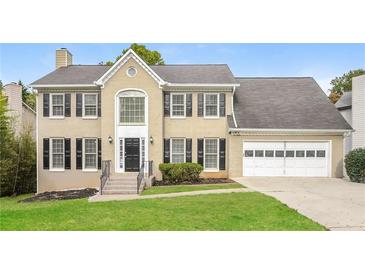 Two-story house featuring a large attached garage at 1851 Furlong Run, Lawrenceville, GA 30043