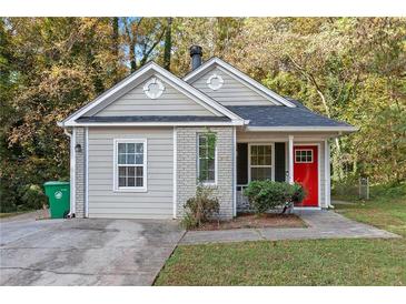 Charming craftsman style home with a red front door and landscaped lawn at 2003 Glenwood Downs Dr, Decatur, GA 30035
