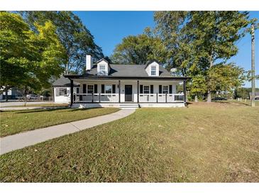 Charming one-story home with white exterior and black accents at 1368 New Hope Rd, Lawrenceville, GA 30045