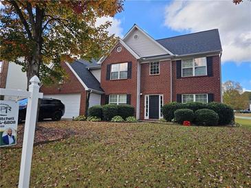 Two-story brick home with landscaped yard at 2334 Pierce Way, Buford, GA 30519