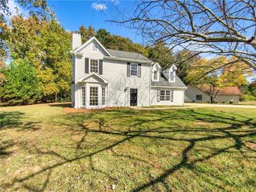 Two-story house with white siding, black shutters, and a landscaped lawn at 120 Birch Creek Cir, Mcdonough, GA 30253