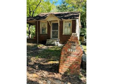 Brick home with front porch and a unique mailbox at 1131 Cato Nw St, Atlanta, GA 30318