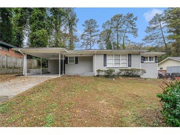 Ranch house with carport, grey brick exterior, and a grassy yard at 1883 Cindy Dr, Decatur, GA 30032