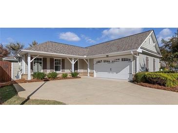 Single-story house with a two-car garage and landscaped yard at 307 Jessica Way, Canton, GA 30114