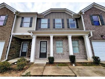 Two-story townhome with brick and siding at 1535 Iris Walk, Jonesboro, GA 30238