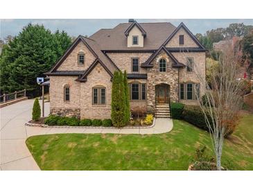 Brick front exterior of a luxurious two-story home with landscaping at 3960 Carissa Trce, Cumming, GA 30040