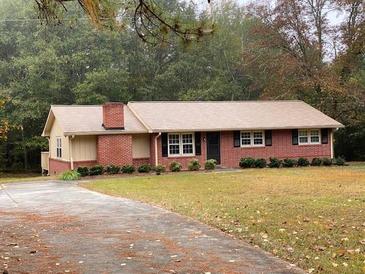 Brick ranch house with a large yard and driveway at 2194 Klondike Sw Rd, Conyers, GA 30094