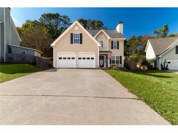 Two-story house with a two-car garage and well-manicured lawn at 215 Mackenzie Ct, Canton, GA 30115