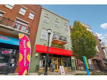 Commercial building exterior with red awning and street-level businesses at 320 Town Center Ave # U206B, Suwanee, GA 30024