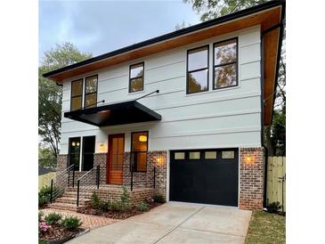 Two story home with modern design, brick and white siding at 322 Reed St, Scottdale, GA 30079