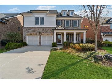 Two-story home with brick and siding, two-car garage, and landscaped lawn at 4884 Kentwood Dr, Marietta, GA 30068