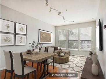 Virtually staged living room with hardwood floors and large windows at 821 Ralph Mcgill Ne Blvd # 3404, Atlanta, GA 30306