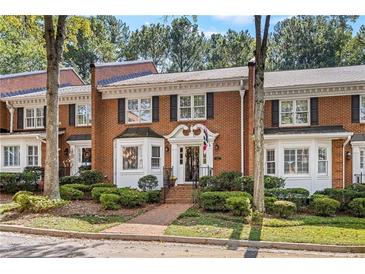 Brick townhouse with white trim and landscaping at 5417 Trentham Dr, Dunwoody, GA 30338