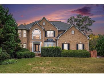 Two story brick home with landscaped yard at 9140 N Links Dr, Covington, GA 30014