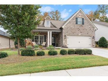 Brick house with two car garage and manicured lawn at 122 Brayden Park Dr, Canton, GA 30115