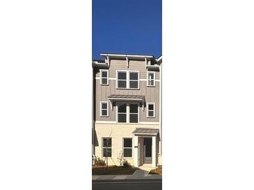 Three story townhome with light beige and gray siding, and a dark gray door at 107 Chestnut Trce # 11, Hapeville, GA 30354