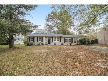 Ranch style home with carport and mature trees at 6940 Kimberly Mill Rd, Atlanta, GA 30349