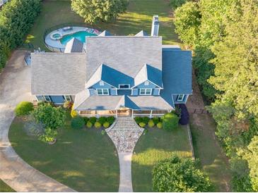 Aerial view of a two-story home with a pool and landscaped yard at 8850 E Carroll Rd, Winston, GA 30187