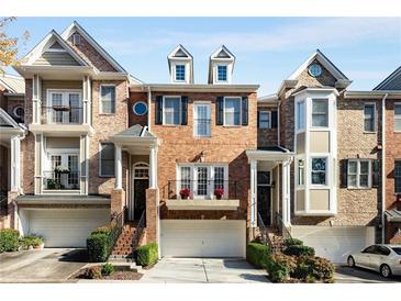 Brick townhouses with attached garages and manicured landscaping at 226 Mclaren Gates Dr, Marietta, GA 30060