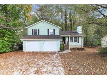 Ranch home with three-car garage and mature trees at 4027 Evelyn Dr, Powder Springs, GA 30127