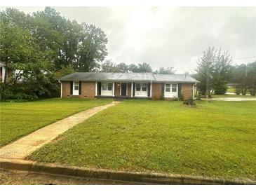 Ranch style brick home with a well-maintained lawn at 3759 Stanford Cir, Decatur, GA 30034