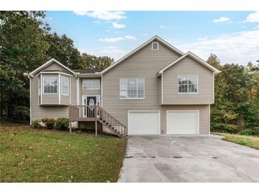 Two-story house with a double garage and landscaped yard at 2791 Willow Tree Overlook, Douglasville, GA 30315