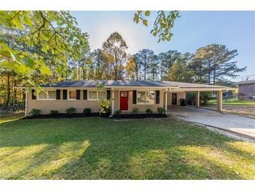 Ranch home with red door and landscaped lawn at 160 Cross Creek Pkwy, Dallas, GA 30157