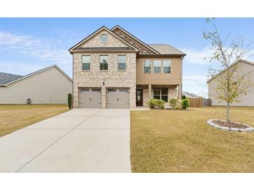 Two-story brick house with attached two-car garage at 1262 Brookstone Cir, Conyers, GA 30012