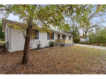 Charming ranch home with updated front porch and landscaping at 200 Sunrise Cir, Riverdale, GA 30274