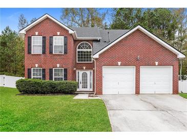 Brick two-story house with a two-car garage and a well-maintained lawn at 6257 Selborn Sw Dr, Atlanta, GA 30331