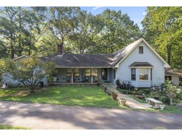 Ranch-style house with a large yard and mature trees at 2371 Leguin Mill Rd, Locust Grove, GA 30248