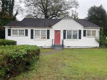 White house with red door and black shutters at 6848 Church St, Lithonia, GA 30058